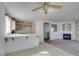 Open-concept kitchen with tiled countertops, wooden cabinets, and access to the living area at 8012 Pottery Creek Dr, Las Vegas, NV 89128