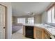 The kitchen has a breakfast bar, a vintage dishwasher and a view of the living room at 8012 Pottery Creek Dr, Las Vegas, NV 89128