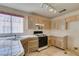 Cozy kitchen with tiled countertops, floral cabinets and stainless steel gas range at 8012 Pottery Creek Dr, Las Vegas, NV 89128