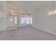 Inviting living room with a front door, large windows and a chandelier at 8012 Pottery Creek Dr, Las Vegas, NV 89128