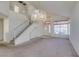 Bright living room with staircase, front door and chandelier at 8012 Pottery Creek Dr, Las Vegas, NV 89128