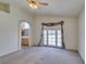 Spacious living room with a view to the Primary bathroom and an exit to the back patio at 8012 Pottery Creek Dr, Las Vegas, NV 89128