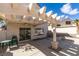 Covered patio area with ceiling fan, outdoor seating, and view of the backyard at 8012 Pottery Creek Dr, Las Vegas, NV 89128
