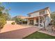 Large backyard features brick-paved area and covered patio for outdoor living at 8476 Tackle Box Ct, Las Vegas, NV 89113