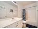 Bathroom featuring a tub and shower combination, toilet, and a vanity with white cabinets at 8476 Tackle Box Ct, Las Vegas, NV 89113