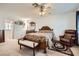 Bedroom featuring neutral carpet, ceiling fan, and a comfortable leather armchair at 8476 Tackle Box Ct, Las Vegas, NV 89113