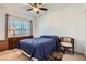 Bedroom features a ceiling fan, window with blinds, bed, and stylish side table at 8476 Tackle Box Ct, Las Vegas, NV 89113