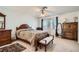 Spacious bedroom with neutral carpet, ceiling fan, and window bringing in natural light at 8476 Tackle Box Ct, Las Vegas, NV 89113