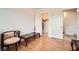 Bedroom with wood-look floors, a closet, and a chair with dark wood trim at 8476 Tackle Box Ct, Las Vegas, NV 89113