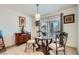 Dining area featuring tile floors, a glass table with seating for four, and natural lighting at 8476 Tackle Box Ct, Las Vegas, NV 89113