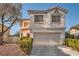 Two-story stucco home with a two-car garage, tile roof and well-maintained landscaping at 8476 Tackle Box Ct, Las Vegas, NV 89113
