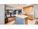 Open-concept kitchen with wood cabinets, tile countertops, and seamless flow to the adjacent living area at 8476 Tackle Box Ct, Las Vegas, NV 89113
