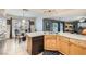 Open kitchen showcasing tile floors, wood cabinets, and a window overlooking the backyard at 8476 Tackle Box Ct, Las Vegas, NV 89113