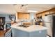 Bright kitchen features wood cabinets, stainless steel appliances, and a tile countertop island with a double sink at 8476 Tackle Box Ct, Las Vegas, NV 89113