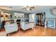 Bright living room featuring hardwood floors, large windows, and traditional-style furnishings at 8476 Tackle Box Ct, Las Vegas, NV 89113