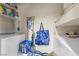 Functional laundry room includes a washer, dryer, and shelving for storage at 8600 W Charleston Blvd # 2078, Las Vegas, NV 89117