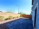 Private backyard featuring a brick-paved patio, gravel landscaping, and a block wall fence at 8694 Glen Echo Ave, Las Vegas, NV 89148