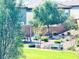 Serene backyard with lush green lawn, picnic table, bench and mature landscaping at 8694 Glen Echo Ave, Las Vegas, NV 89148