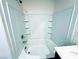 Bright bathroom features tiled shower-tub combo with built-in shelving and modern fixtures at 8694 Glen Echo Ave, Las Vegas, NV 89148