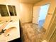 A well-lit bathroom with double sink vanity, modern fixtures, and tile flooring provides a functional and stylish space at 8694 Glen Echo Ave, Las Vegas, NV 89148
