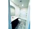 Clean and bright bathroom featuring a shower-tub combo and a vanity with dark wood cabinets at 8694 Glen Echo Ave, Las Vegas, NV 89148