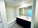 Bright bathroom features a double sink vanity and a shower-tub combo at 8694 Glen Echo Ave, Las Vegas, NV 89148