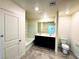 Bright bathroom with double sink vanity, tiled floors, and bathtub shower combo at 8694 Glen Echo Ave, Las Vegas, NV 89148