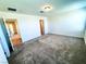 A spacious bedroom featuring soft carpeting, neutral walls, and multiple doorways for convenient access at 8694 Glen Echo Ave, Las Vegas, NV 89148