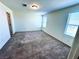 Comfortable bedroom with soft carpeting, neutral walls, and plenty of natural light from the windows at 8694 Glen Echo Ave, Las Vegas, NV 89148