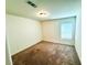 Bright bedroom with neutral carpet, a ceiling light, and window with blinds at 8694 Glen Echo Ave, Las Vegas, NV 89148