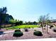 Expansive community greenspace with trees, plants, walking path, and benches to relax at 8694 Glen Echo Ave, Las Vegas, NV 89148