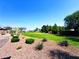 Serene community lawn surrounded by mature trees, offering a perfect space for relaxation and recreation at 8694 Glen Echo Ave, Las Vegas, NV 89148