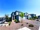 Lovely two-story home showcasing a paved driveway, stone landscaping, and attached garage at 8694 Glen Echo Ave, Las Vegas, NV 89148