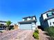 Inviting two-story home featuring a paver driveway, low-maintenance landscaping, and a serene suburban setting at 8694 Glen Echo Ave, Las Vegas, NV 89148