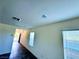 Long bright hallway with tile floors and several windows, and a view of the front door at 8694 Glen Echo Ave, Las Vegas, NV 89148
