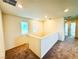 Upstairs hallway featuring plush carpeting, natural light from the windows, and doorways leading to various rooms at 8694 Glen Echo Ave, Las Vegas, NV 89148