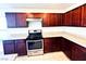 Kitchen featuring stainless steel appliances, granite countertops, and dark wood cabinets at 8694 Glen Echo Ave, Las Vegas, NV 89148