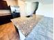 View of the kitchen island with granite counters and stainless steel sink in an open, airy home at 8694 Glen Echo Ave, Las Vegas, NV 89148