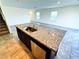 Open-concept kitchen features granite countertops, stainless steel appliances, and tile flooring at 8694 Glen Echo Ave, Las Vegas, NV 89148