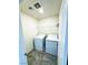 Convenient laundry room with side-by-side washer and dryer and tiled floor at 8694 Glen Echo Ave, Las Vegas, NV 89148