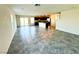 Open floor plan living area with tile floors leading to the kitchen and out to the yard at 8694 Glen Echo Ave, Las Vegas, NV 89148
