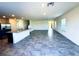 Spacious living room featuring modern tile flooring, granite countertops, stainless steel appliances, and abundant natural light at 8694 Glen Echo Ave, Las Vegas, NV 89148