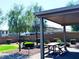 Community picnic area with a shaded gazebo, picnic table, and lush landscaping at 8694 Glen Echo Ave, Las Vegas, NV 89148