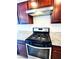 Close-up of a gas stove with stainless steel hood and granite countertops in a modern kitchen at 8694 Glen Echo Ave, Las Vegas, NV 89148