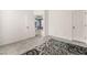 Open floor plan features a smooth transition into an adjacent living space with large area rug and ample natural light at 8942 Partridge Hill St, Las Vegas, NV 89148