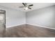 Spacious bedroom featuring modern wood-look flooring, neutral walls, and a ceiling fan for added comfort at 8942 Partridge Hill St, Las Vegas, NV 89148