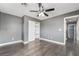 Spacious bedroom boasts modern gray walls, ceiling fan, and wood-look flooring at 8942 Partridge Hill St, Las Vegas, NV 89148