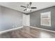 This bedroom features a ceiling fan, window, and laminate wood-look flooring at 8942 Partridge Hill St, Las Vegas, NV 89148