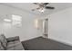 Bright bedroom with white walls, ceiling fan, and natural light from the large window at 8942 Partridge Hill St, Las Vegas, NV 89148