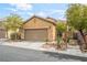 Charming single-story home featuring a two-car garage and well-maintained desert landscaping in front at 8942 Partridge Hill St, Las Vegas, NV 89148